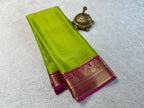 Green saree with pink border on a white background